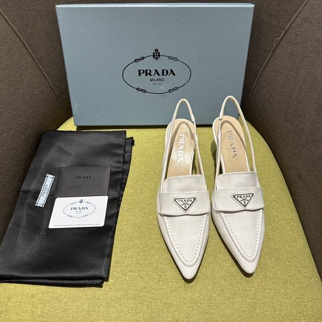 出厂价 Prada 普拉达2023Ss 这款线条曼妙有致的锥形漆皮后饰带鞋演绎刚柔并济的美学。标志性的涂珐琅金属三角形徽标跃然饰于鞋面，平添点睛之笔。 面料 :